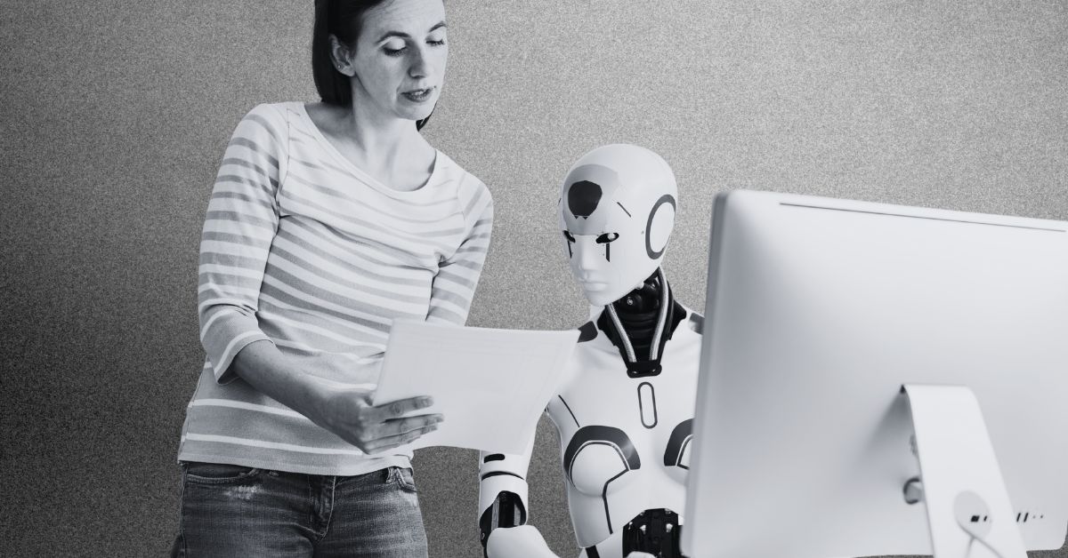 Book Download The Leadership Gap Agentic AI Just Made Visible | 120VC Woman and humanoid robot review documents together at a desk with a computer nearby.